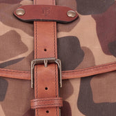 Close-up of the Tom Beckbe Classic Camo Weekender Duffel Bag featuring a brown leather strap and metal buckle.