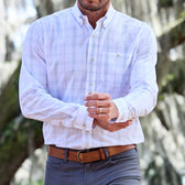 Man in a Tom Beckbe Monroe Poplin Shirt and gray pants adjusts his sleeve outdoors.