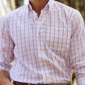 Close-up of a person wearing a Monroe Poplin Shirt by Tom Beckbe outdoors with rolled-up sleeves.