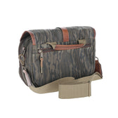 Tom Beckbe Canvas Blind Bag in Mossy Oak Original Bottomland with brown leather accents, front zip pocket, and beige strap.