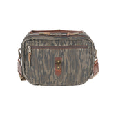 Tom Beckbes Canvas Blind Bag in Mossy Oak Original Bottomland features brown leather accents and a front zipper pocket.