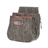 Tom Beckbe Canvas Shell Bag in Mossy Oak Original Bottomland with brown leather trim, embossed emblem, and double pockets.