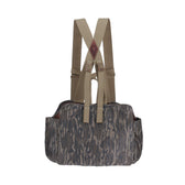 Tom Beckbes Strap Vest in Mossy Oak Original Bottomland features adjustable beige shoulder straps on a white background.