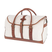 The Perdido Canvas Weekender Duffel Bag by Tom Beckbe features brown leather straps and trim on white canvas.