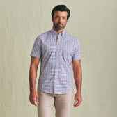 A man wears the Tom Beckbe Powell Performance Shirt (Short Sleeve) and beige pants, facing the camera against a plain backdrop.