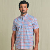 Man with short dark hair and beard wearing a Tom Beckbe Powell Performance Shirt, short sleeve, multicolored plaid.
