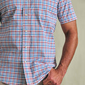 Person wearing the Tom Beckbe Powell Performance Shirt (Short Sleeve) with hand in pocket.