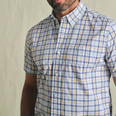 Man wearing the Tom Beckbe Powell Performance Short Sleeve Shirt in blue, yellow, and white plaid, shown waist up.