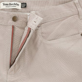 Close-up of Tom Beckbe Reid Straight Leg Cotton Chino Pant in beige, showing button, zipper, and waistband label.