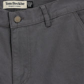 Reid Short by Tom Beckbe: Mid-rise gray pants with brass zip fly, button, belt loops; designed in AL, made in Portugal.