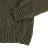 Close-up of the Tom Beckbe Saunders Crewneck Sweater in olive green, showing ribbed cuffs and hem on a white background.