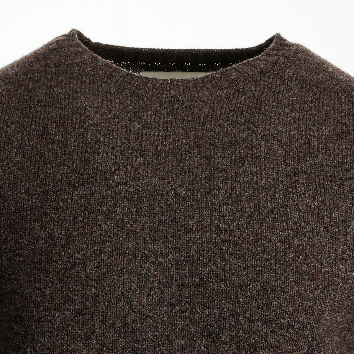 Close-up of the Tom Beckbe Saunders Crewneck Sweater in brown wool, styled on a white background.