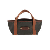 Tom Beckbe Shell Box Carrier: small dark green canvas tote with brown handles, leather patch, and metal rivets.