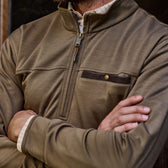 Someone in a brown Tom Beckbe Tucker Fleece Quarter Zip with arms crossed and a buttoned chest pocket.