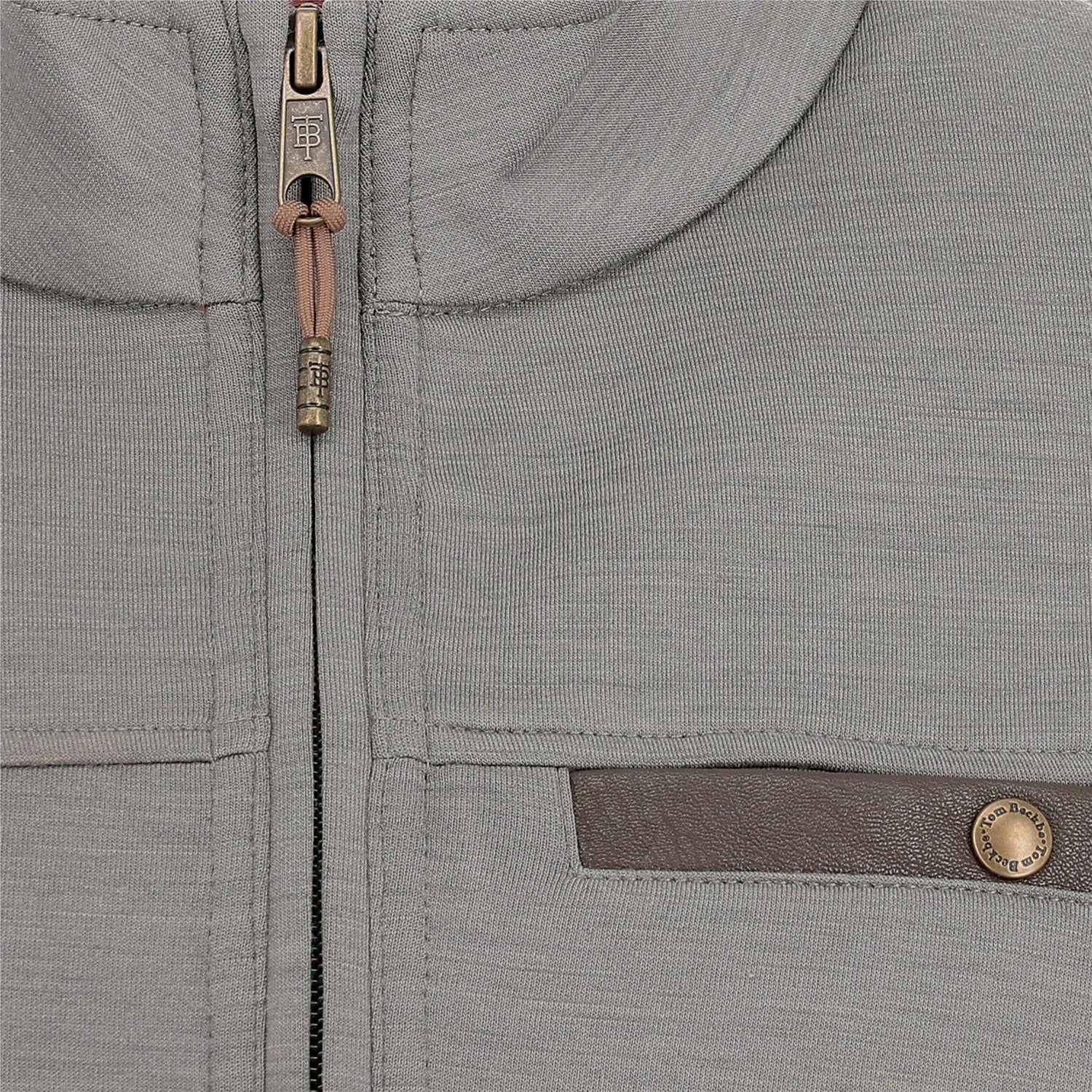 Close-up of the Tom Beckbe Tucker Fleece Quarter Zip highlighting the zipper, buttoned pocket, and textured fabric.