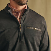 Man in Tom Beckbe Tucker Fleece Quarter Zip over plaid shirt, highlighting chest pocket and zipper detail.