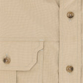 Close-up of Tom Beckbe Uplander Shirt in beige cotton oxford with buttoned pocket flap and placket.