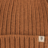 Close-up of the Tom Beckbe Wool Cap in brown lambswool knit with a folded brim and monogram tag.