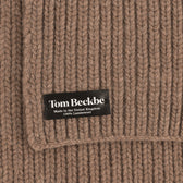 Close-up of Tom Beckbe Wool Scarf in brown ribbed knit with black label, 100% lambswool, made in the UK.