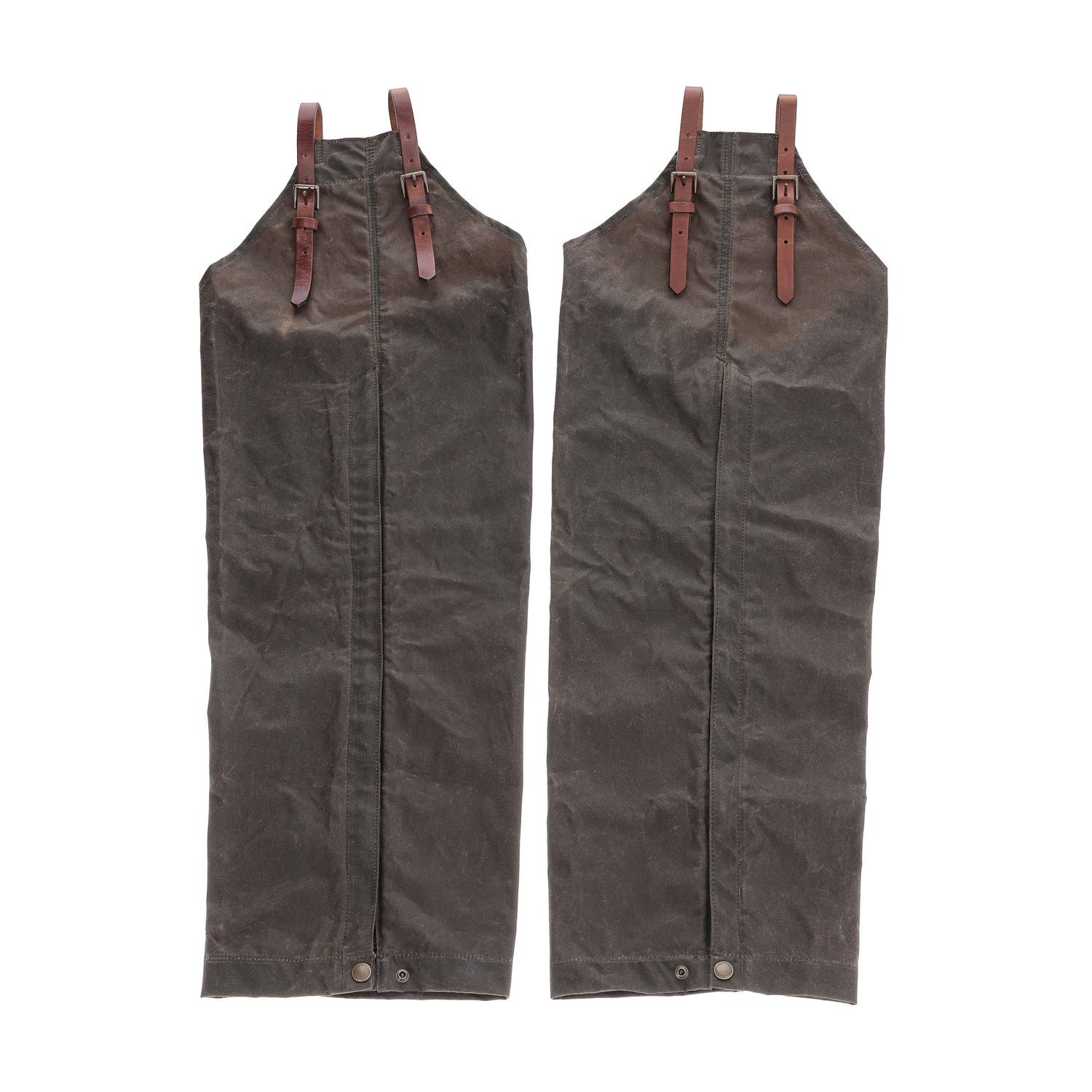 Tom Beckbe Waxed Canvas Chaps in brown with leather straps and buckles, shown on a white background.