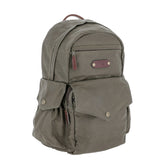 The Tom Beckbe DU Canvas Backpack is olive green with a front zipper, side flap pockets, and a padded laptop sleeve.