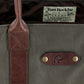 A close-up of the DU Canvas Carryall by Tom Beckbe, featuring leather straps and a Ducks Unlimited label.