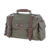 The Tom Beckbe DU Canvas Field Bag is a green waxed cotton satchel with brown leather straps and buckles.