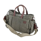 Tom Beckbe DU Canvas Utility Bag in green waxed cotton with brown leather handles, shoulder strap, and exterior pockets.