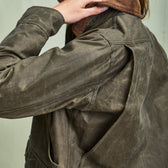 Woman in Tom Beckbe Womens Steward Jacket, hand on collar, side view.