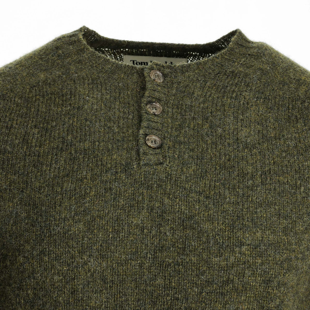Close-up of Tom Beckbe Albemarle Henley Sweater in green wool, round neck, and three brown buttons. Made in Scotland.
