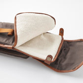 The Tom Beckbe Canvas Gun Sleeve is fleece-lined in brown and cream, with an open flap, zipper, and button closure.